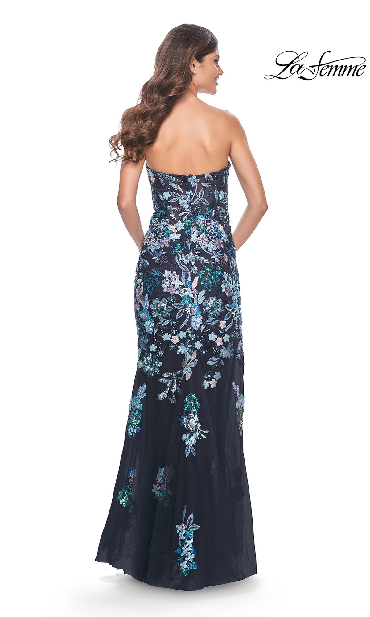 Woman wearing the La Femme Strapless Sequin-Print Prom Dress 32251 with blue and white floral embroidery, shown from the back. This elegant long prom dress offers a stunning silhouette for any special event.